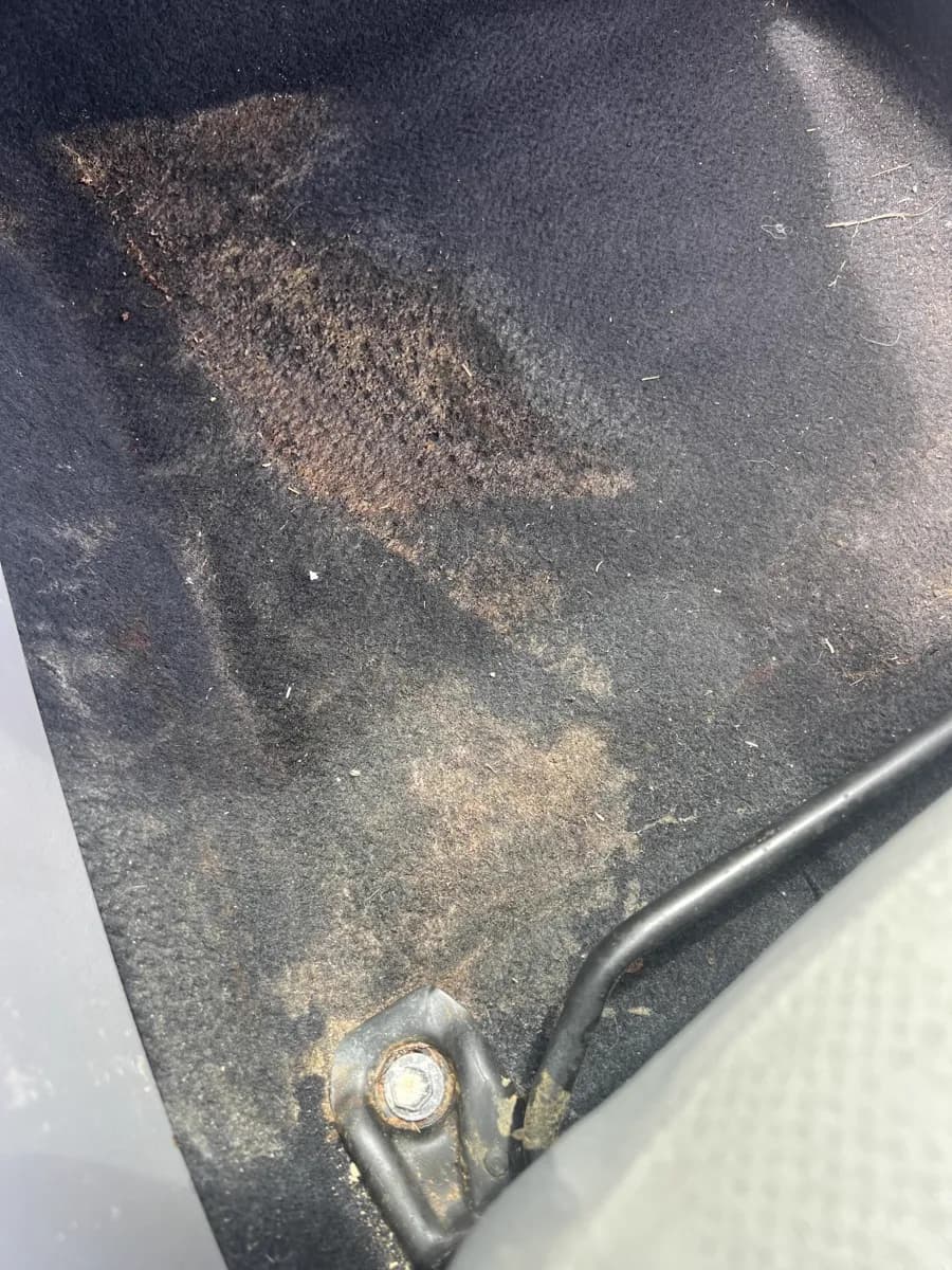 Passenger floor carpet — before